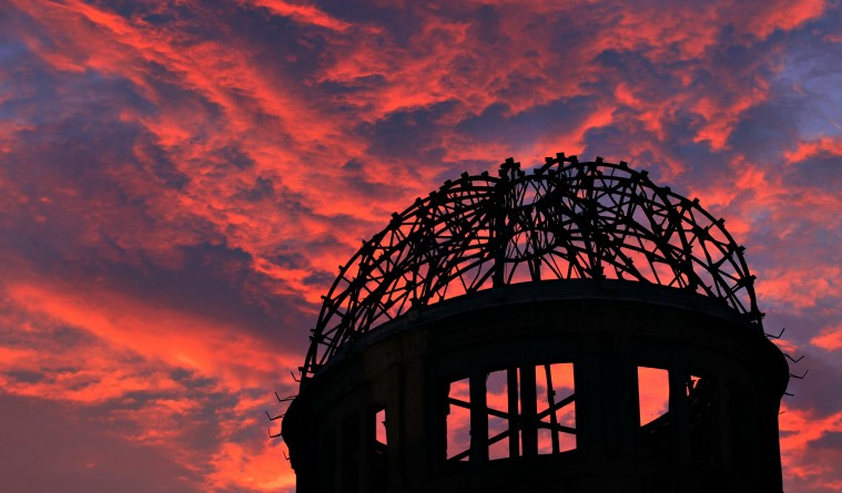 The Atomic Bomb Dome is silhouetted at sunset in Hiroshima, west