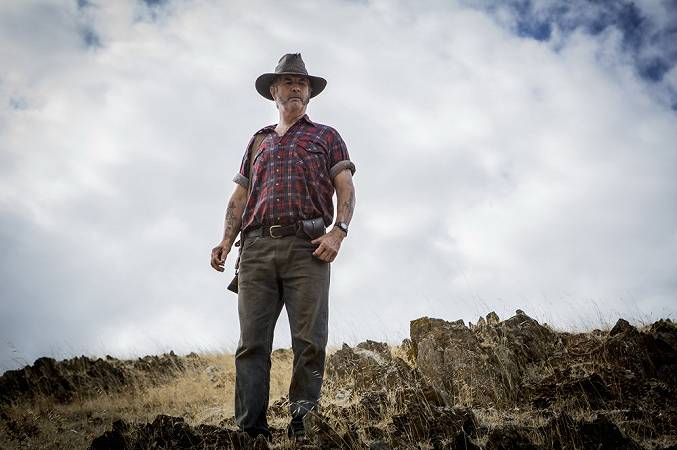 WolfCreek2_John-Jarratt-as-Mick-Taylor_-with-gun-_-from-below-1