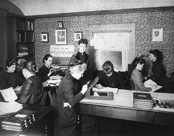 arvard Computers at work, circa 1890, including Henrietta Swan Leavitt seated, third from left, with magnifying glass (1868–1921), Annie Jump Cannon (1863–1941), Williamina Fleming standing, at center (1857–1911), and Antonia Maury (1866–1952).