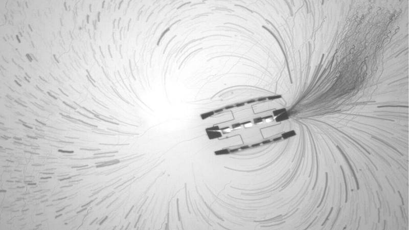 proiezione in time-lapse delle traiettorie delle particelle traccianti vicino a un robot costituito da tre motori collegati tra loro